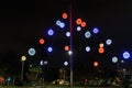 Night view of colourful Christmas balls decorations at a city square.