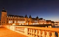 Night view of Conciergerie Castle and Bridge of Change -Pont au Change over river Seine. Paris, France Royalty Free Stock Photo