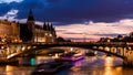 Night view of Conciergerie Castle and Pont Notre-Dame bridge over river Seine. Paris, France Royalty Free Stock Photo