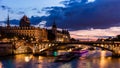 Night view of Conciergerie Castle and Pont Notre-Dame bridge over river Seine. Paris, France Royalty Free Stock Photo