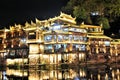 Night view of Diaojiaolou traditional Chinese gabled wooden houses built on stilts be preserved in Fenghuang old city Phoenix