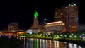 Night view of Downtown Columbus with illuminated buildings.