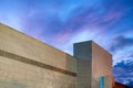 Night view exterior of shopping mall centre over blue clouds in uk