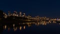 Night view of False Creek bay in the downtown of Vancouver, Canada with illuminated high-rise buildings reflected in water. Royalty Free Stock Photo