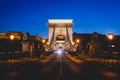 Night view of a famous Budapest Szechenyi Chain Bridge, a suspension bridge that spans the River Danube between Buda and Pest, the Royalty Free Stock Photo