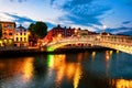 Night view of famous illuminated Ha Penny Bridge in Dublin, Ireland at sunset Royalty Free Stock Photo