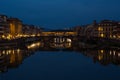 Night view of Florence with the Arno River and mirror bridges reflections