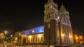 Night view of the front of San Pedro de Guaranda Cathedral Church illuminated with yellow, blue and purple lights