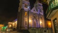 Night view of the front of San Pedro de Guaranda Cathedral Church illuminated with yellow and purple lights