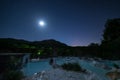 Night view: geothermal pool and hot spring in Tuscany, Italy. Bagni San Filippo natural thermal waterfall in the evening by moon Royalty Free Stock Photo