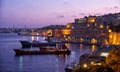 The night view of Grand Harbour with the cargo ships moored near Royalty Free Stock Photo