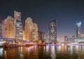 Night view of high-rise buildings of residential district in Dubai Marina And Tourist Boat, Sightseeing Boat Sailing On Royalty Free Stock Photo