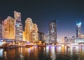 Night view of high-rise buildings of residential district in Dubai Marina And Tourist Boat, Sightseeing Boat Sailing On Royalty Free Stock Photo