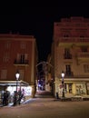 Night view of historic buildings with illuminated facades at square Place du Palais in old district Monaco-Ville, Monaco.