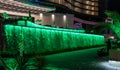 Night view of hotel Palm apartments waterfall illuminated by colorful lights in Batumi city - the capital of Adjara in Georgia Royalty Free Stock Photo