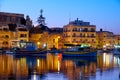 The night view of houses and hotels of Marsaskala reflecting in