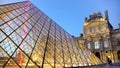 Night view of illuminated Louvre Palace with glass pyramid, famous Paris sights Royalty Free Stock Photo