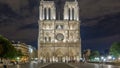 Night View of Notre Dame de Paris timelapse, France and square in front of the cathedral with people Royalty Free Stock Photo