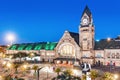 view of the illuminated old railway station building with clock tower in Metz city