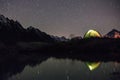Night view of illuminated tent near lake Royalty Free Stock Photo
