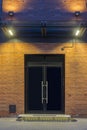 Night view. Industrial building. Large doors in a red brick building. The entrance to the office. Facade Royalty Free Stock Photo