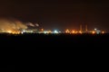 Night view of industrial district of the city and smoke pipes of factory Royalty Free Stock Photo