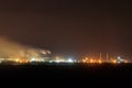 Night view of industrial district of the city and smoke pipes of factory Royalty Free Stock Photo