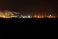 Night view of industrial district of city and smoke pipes of factory Royalty Free Stock Photo