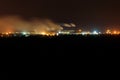 Night view of industrial district of city and smoke pipes of factory Royalty Free Stock Photo