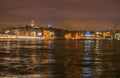 Night view of Istanbul cityscape Galata Tower with floating tourist boats in Bosphorus ,Istanbul Turkey