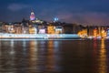 Night view of Istanbul cityscape Galata Tower with floating tourist boats in Bosphorus ,Istanbul Turkey