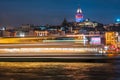 Night view of Istanbul cityscape Galata Tower with floating tourist boats in Bosphorus ,Istanbul Turkey