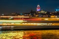 Night view of Istanbul cityscape Galata Tower with floating tourist boats in Bosphorus ,Istanbul Turkey