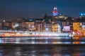 Night view of Istanbul cityscape Galata Tower with floating tourist boats in Bosphorus ,Istanbul Turkey