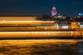 Night view of Istanbul cityscape Galata Tower with floating tourist boats in Bosphorus ,Istanbul Turkey