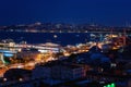 Night view of Istanbul, scenic cityscape with buildings in lights, bridge, bay and blue sky with full moon, Turkey Royalty Free Stock Photo