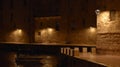 Night view of lanterns illuminating old houses, coastal road in Monopoli, Italy