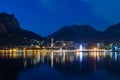 Night view of Lecco reflected on Lake Como with the mountains in Royalty Free Stock Photo
