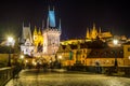 NIght view of the Lesser Town Bridge Tower, form the entrance to the Lesser Town from Charles Bridge, and Prague Castle, the Royalty Free Stock Photo