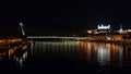 Night view of the lighted SNP bridge over Danube river and castle. Bratislava, Slovakia Royalty Free Stock Photo