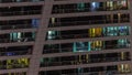 Night view of glowing windows in apartment tower timelapse.