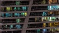 Night view of glowing windows in apartment tower timelapse.