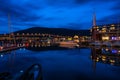 Night view of marina area in Tromso with Tromso Bridge in the distance Royalty Free Stock Photo