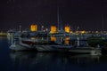 Night view with Medieval Rhodes Town Windmills and yachts, Mandraki harbor, Greece