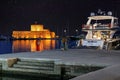 Night view with Medieval Saint Nicolas Fortress Tower in the Mandraki Marina Port, Rgodes, Greece