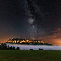 Night view of the Milky Way above the illuminated Koenigstein Fortress. The enlightened Konigstein fortress and the fog in Royalty Free Stock Photo