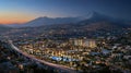 Night View of Modern City Development Mountain Range Background Illuminated Buildings Highway AI generated. Royalty Free Stock Photo