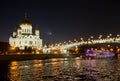 Night view of Moscow Christ the Savior Cathedral, Patriarshy Bridge, embankment and Moskva river with pleasure boat