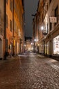 Night view of narrow illuminated empty street in the historic Old Town in Stockholm Sweden. Royalty Free Stock Photo
