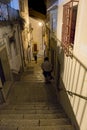 Night view of a narrow narrow cobblestone alley with steep stairs a Royalty Free Stock Photo